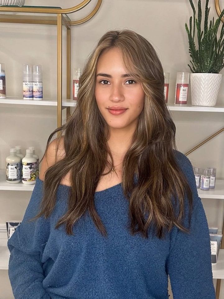 Brunette with face-framing blonde highlights