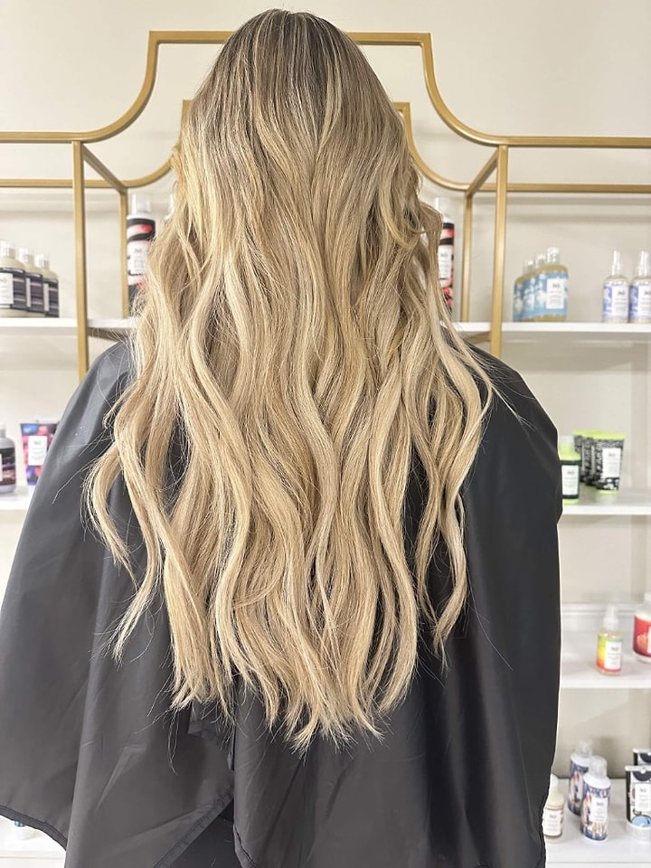 Sandy blonde balayage with soft waves
