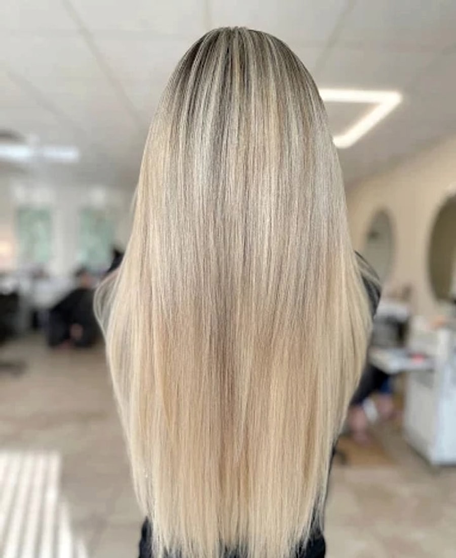 Straight platinum balayage with a soft shadow root