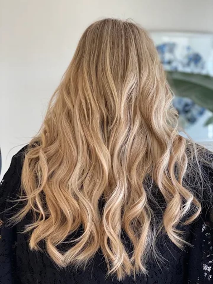 Long honey blonde beach waves from behind